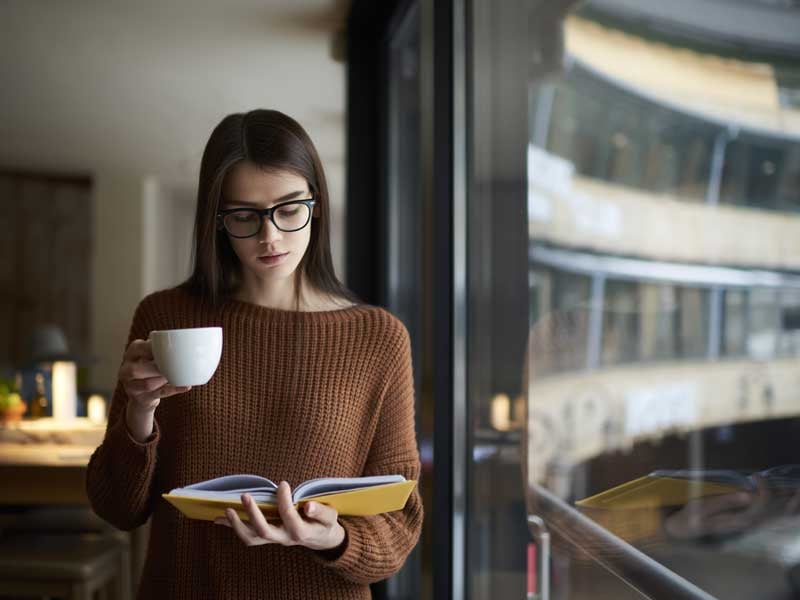 Mujer ejecutiva leyendo un libro para actualizar sus conocimientos