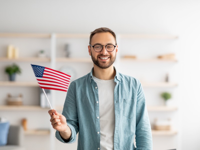 becas-para-estudiantes-joven-sostiene-bandera-estadounidense